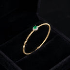 14K Gold Emerald Diamond Flexi-Bangle on display – pulsera de oro real con esmeralda