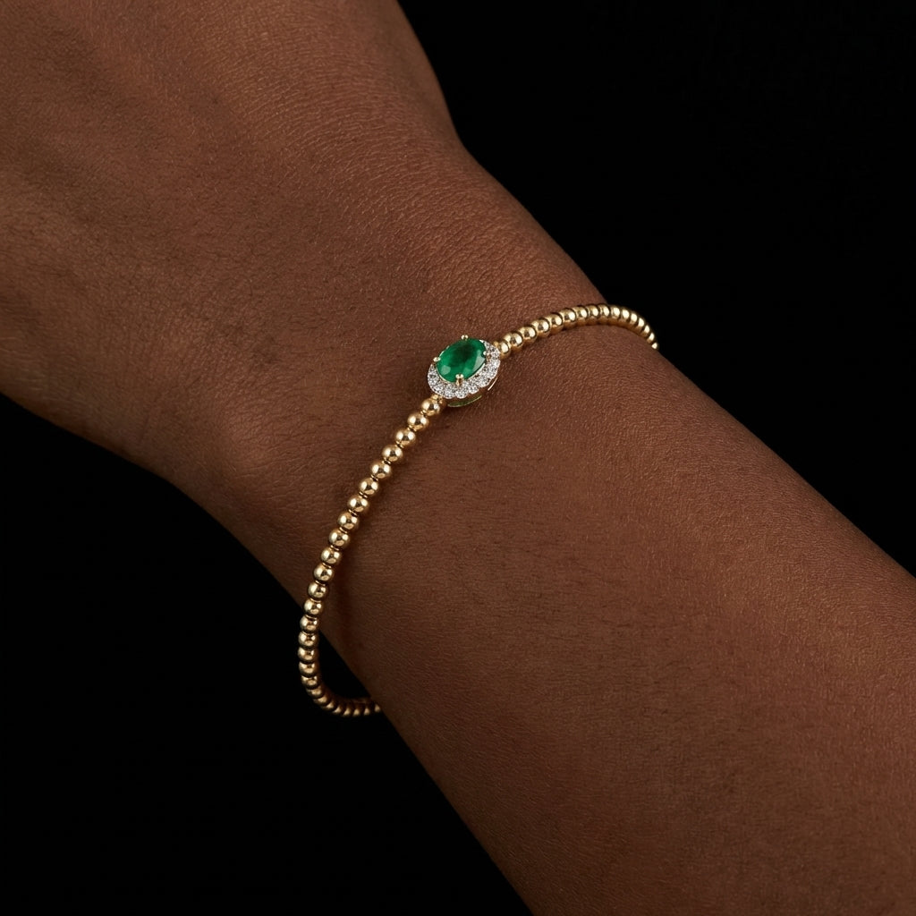 Real 14K Gold Emerald Bangle side view on wrist – solid gold quinceañera bracelet