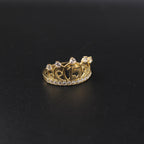 Gold crown-shaped ring with gemstones on a black background
