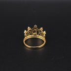 Gold crown-shaped ring on a black background