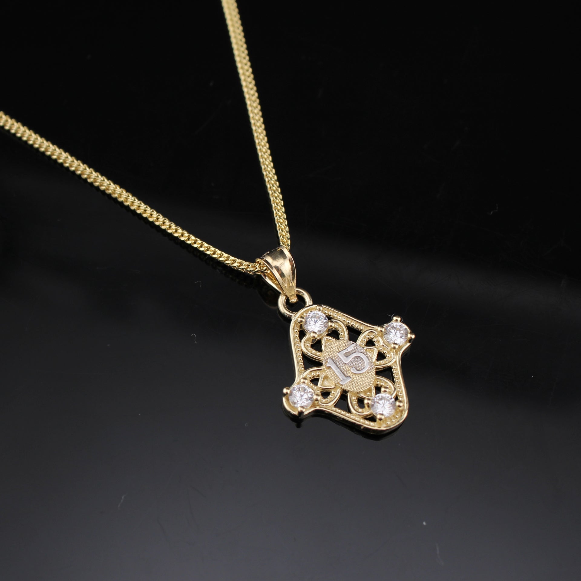 Real 10K Quinceañera Charm on cream background – solid gold sweet 15 pendant